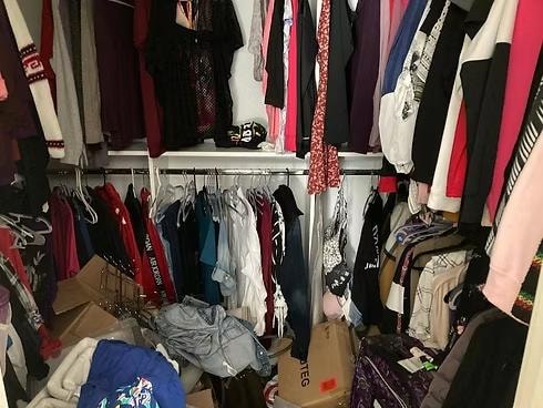 Walk-in closet before organizing — overstuffed and hard to navigate, East Bay professional organizer