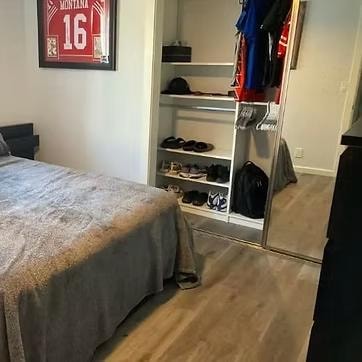 Clean organized bedroom with open closet after professional organizing by Kiera Rain, Fremont CA