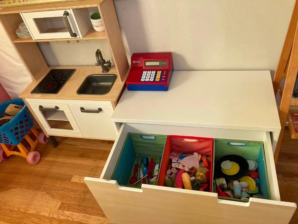 Children's play kitchen and toy storage organized by Kiera Rain, Orinda CA